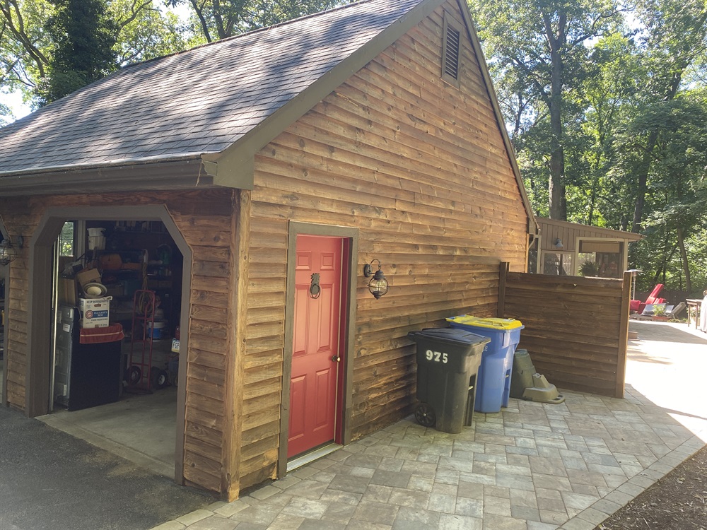 A garage with freshly stained wooden siding.